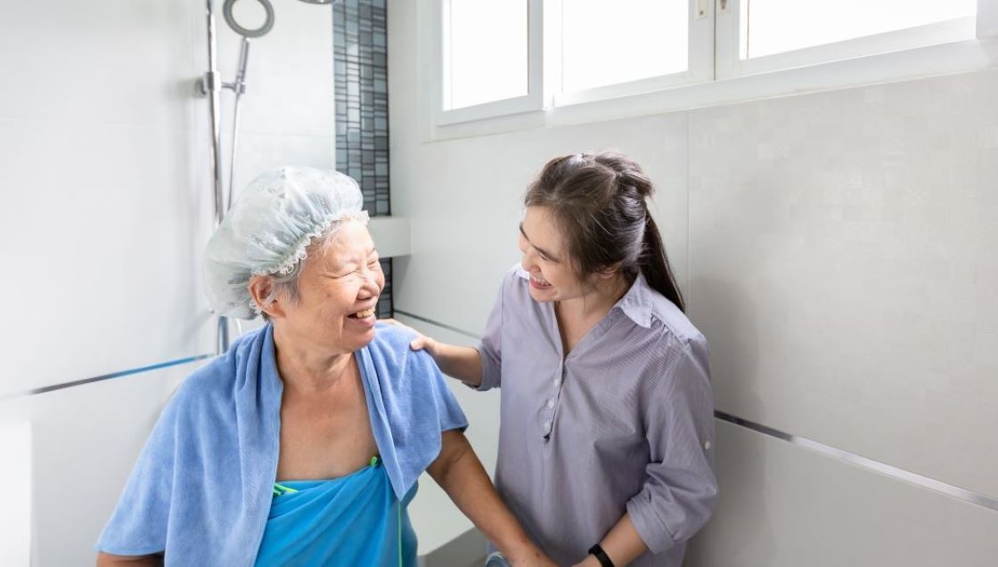Caregiver assisting with shower care