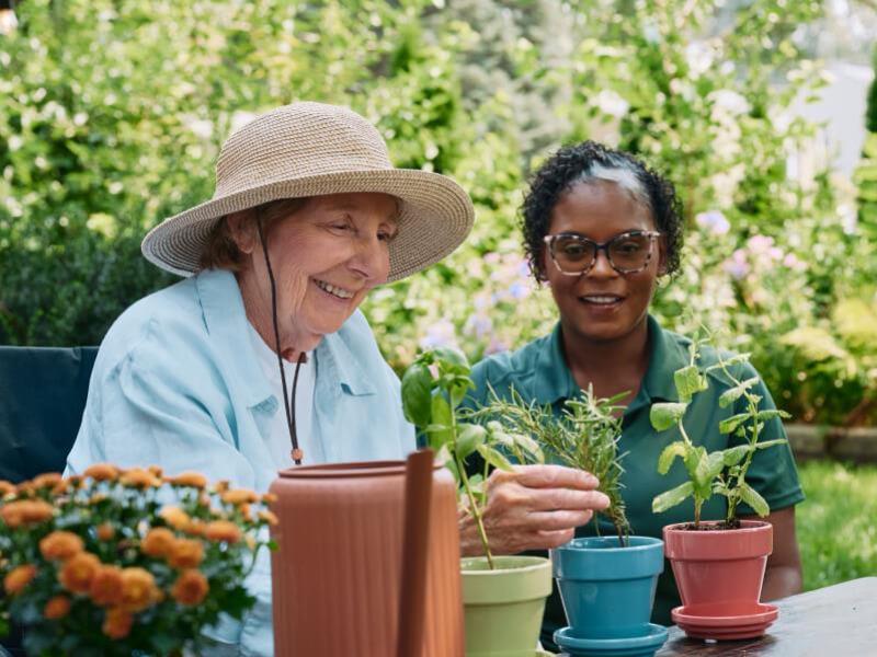 Caregiver and client enjoying gardening together